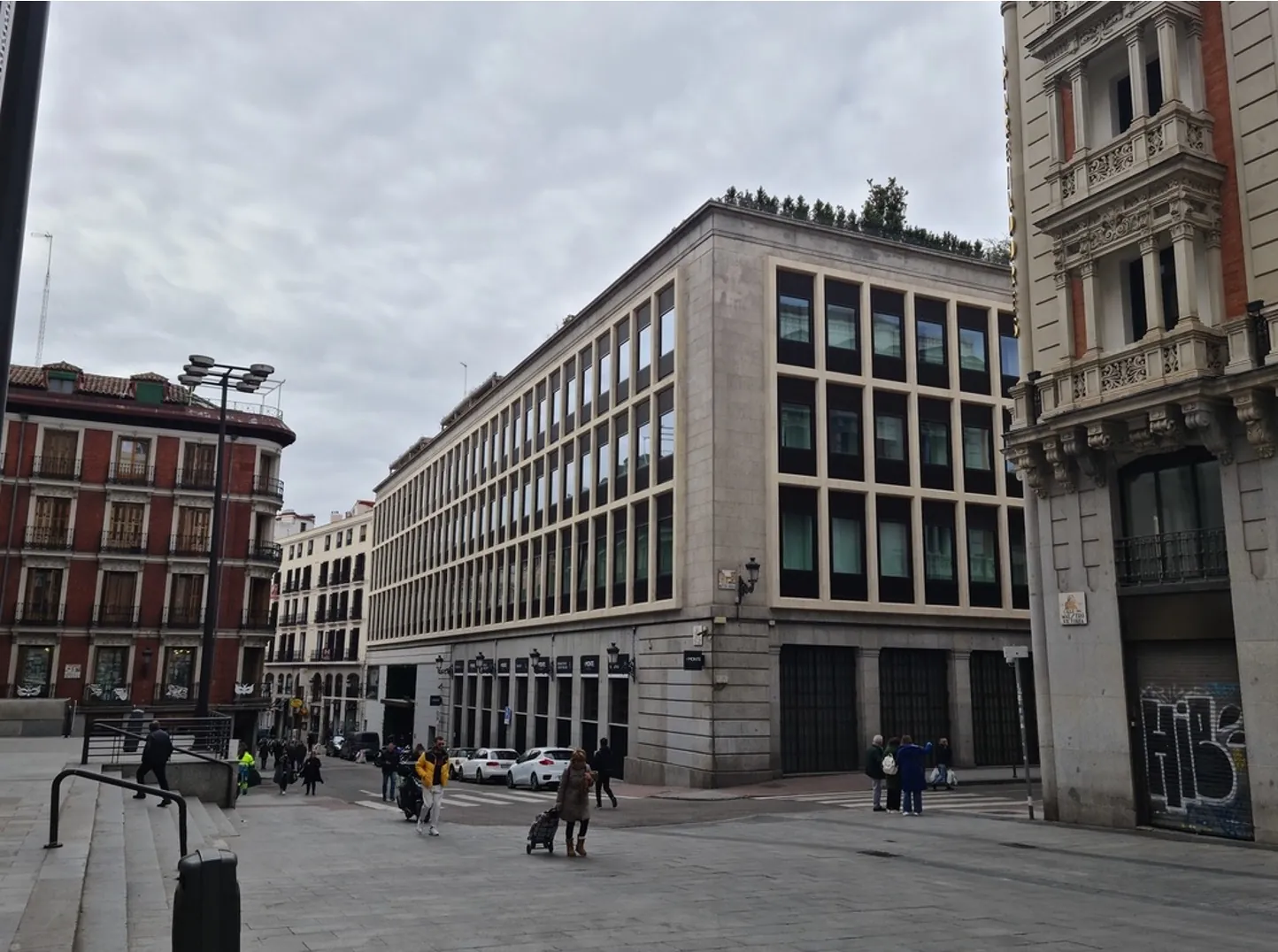 Commercial building frontage with a grid of black-framed glazed units at street level and above