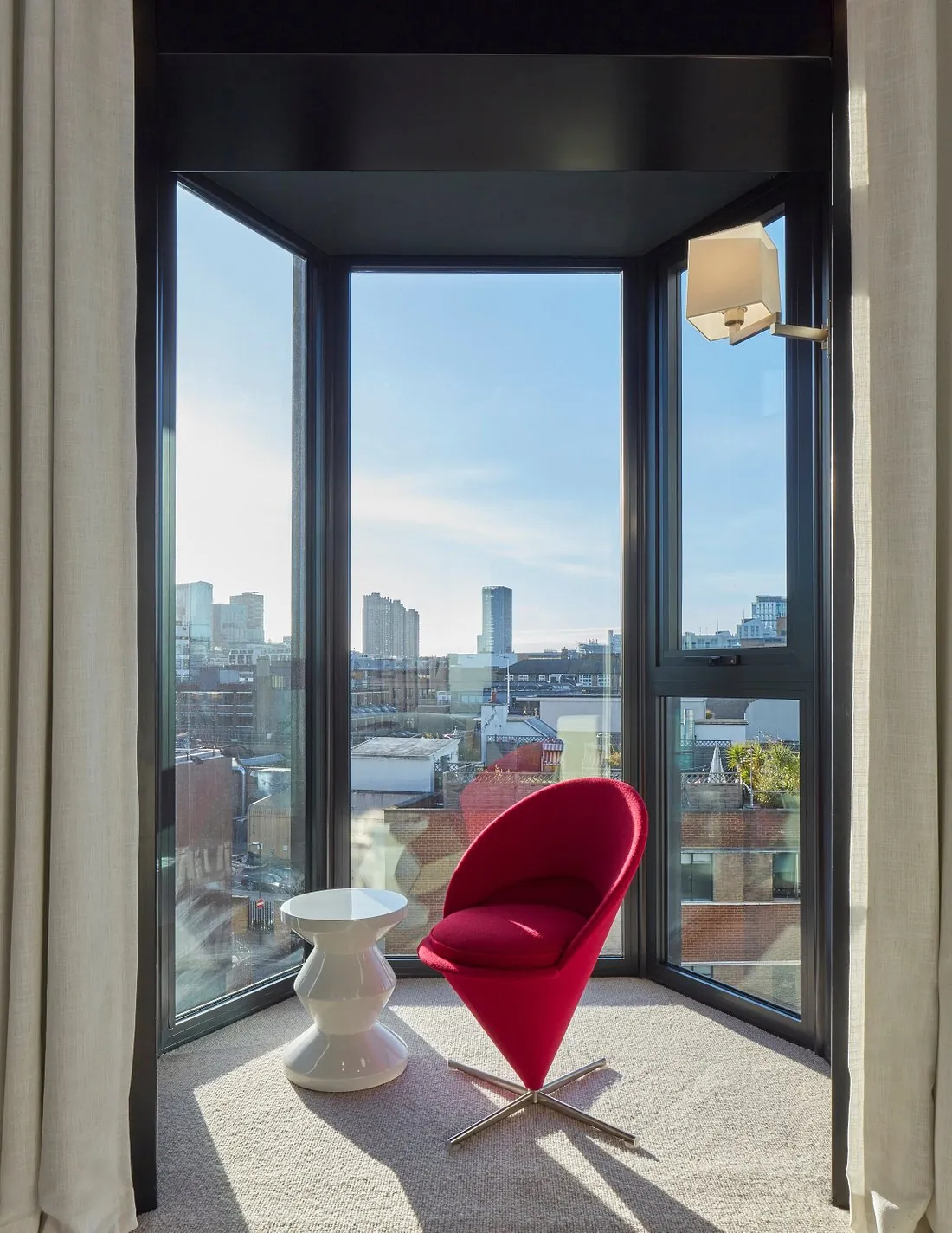 Interior view through a black-framed bay window unit with a fixed pane and side opening lights